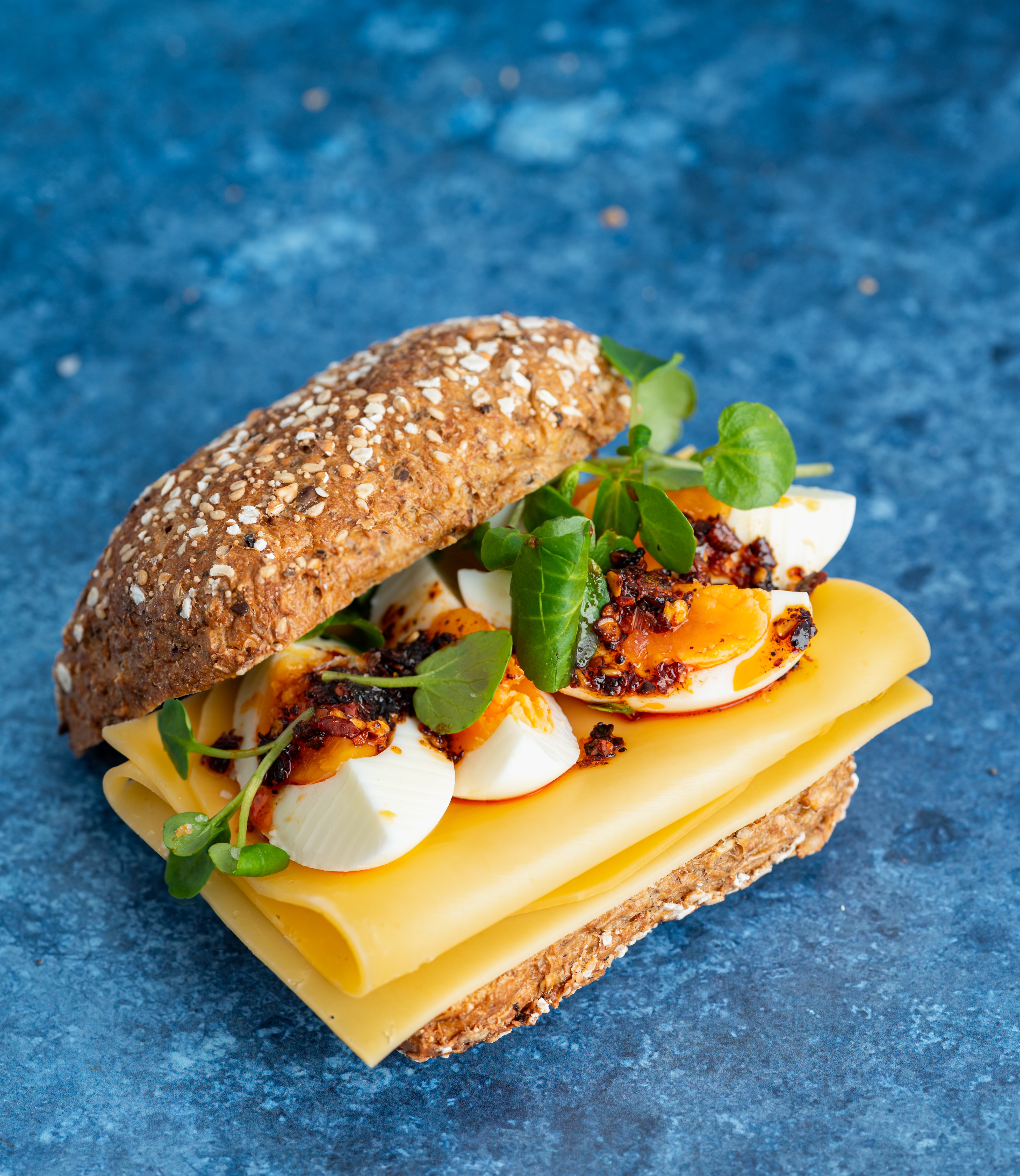 Whole-wheat roll with Beemster® Aged cheese, hard-boiled egg, and crispy chili oil